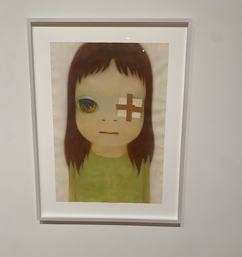 A photo of Yoshitomo Nara's Eyepatch, depicting a young girl with a big head and eyes, of which one is covered by an eyepatch'